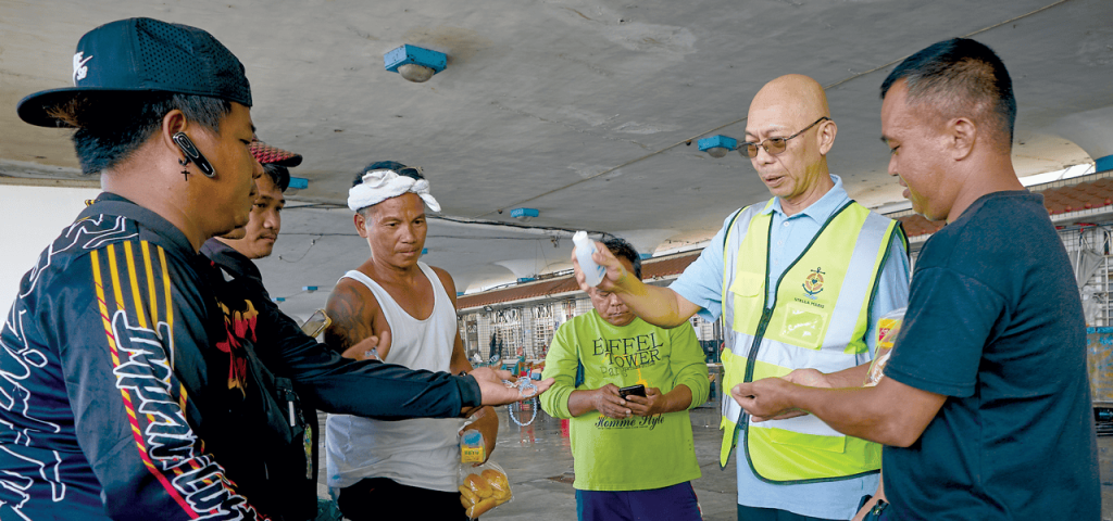 El Padre Maryknoll Joyalito Tajonera bendice los rosarios de pescadores migrantes de las Filipinas. Además de servicios pastorales, el sacerdote ofrece refugio para migrantes en Taiwán. (Paul Jeffrey/Taiwán)