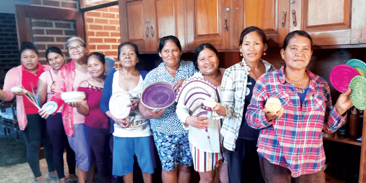 Las mujeres artesanas mojeño-trinitarias de la comunidad Santísima Trinidad en la Amazonía boliviana muestran sus piezas de cestería que venden para sostener sus hogares. (Alejandro Marina, M.M./Bolivia)