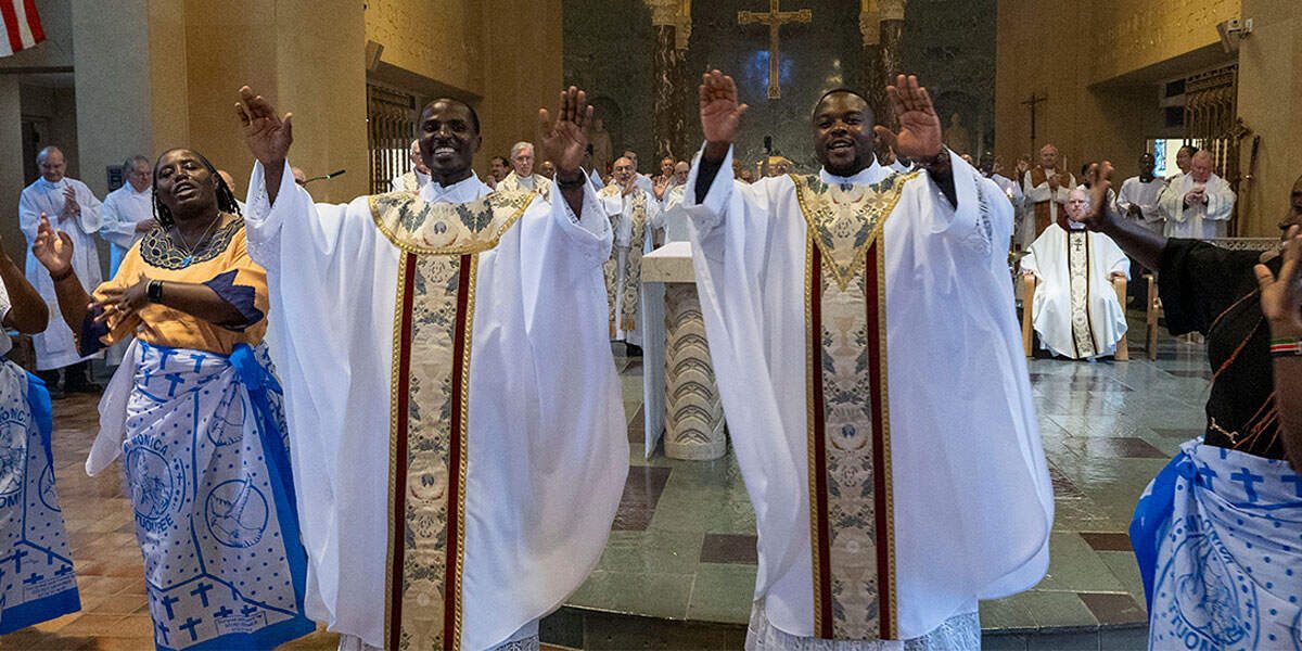Los Padres Maryknoll Charles Ogony (izquierda) y Joshua Maondo (derecha) celebran su ordenación junto a otros misioneros Maryknoll, miembros de la comunidad de Kenia en Estados Unidos y feligreses de las parroquias en las que hicieron voluntariado, el 8 de junio del 2024 en la Capilla Nuestra Señora de los Apóstoles en el campus de la Sociedad Misionera Maryknoll en Ossining, Nueva York. (Octavio Durán, Nueva York)