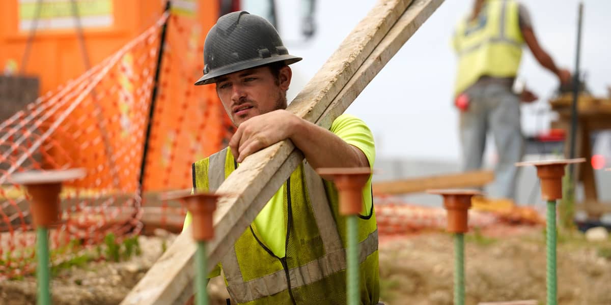 Un trabajador transporta madera en una obra de construcción de una autopista en Stony Brook, Nueva York, el 30 de agosto de 2022. (Archivo de OSV News/CNS, Gregory A. Shemitz)