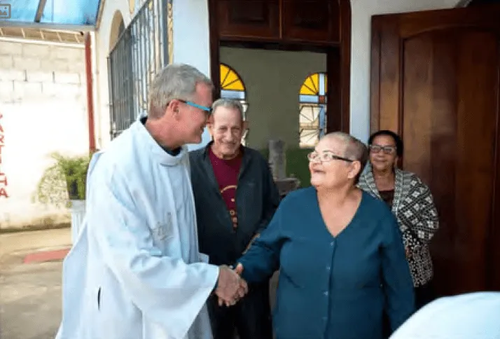 Fr. Dennis greeting parishioners while on mission in Brazil