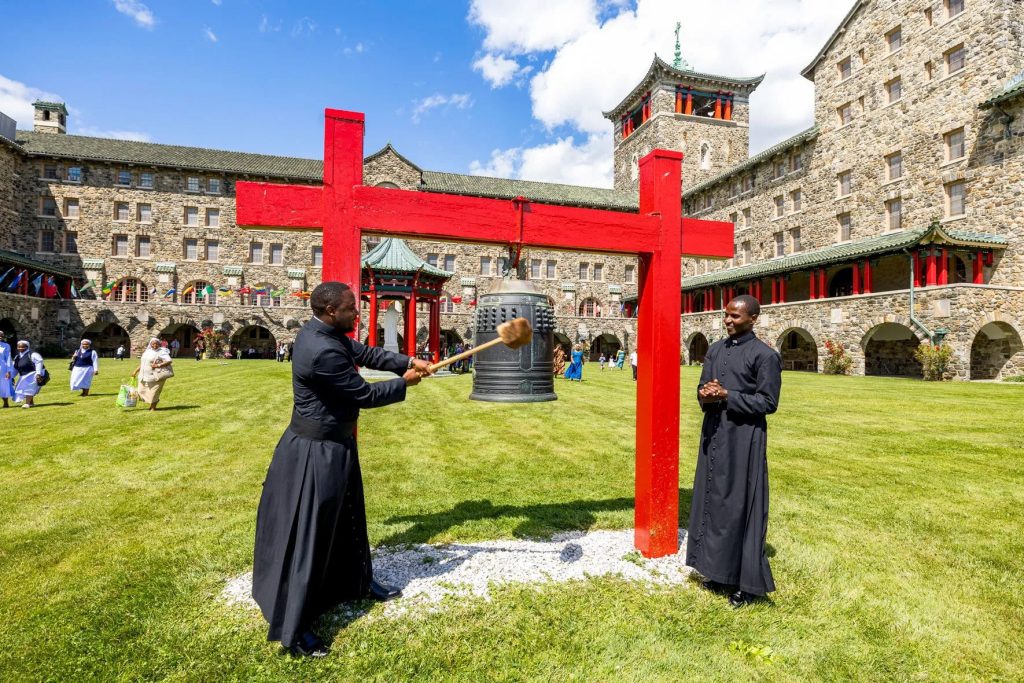 Father Charles Ogony and Father Joshua Maondo ring the bell at the Maryknoll Seminary.