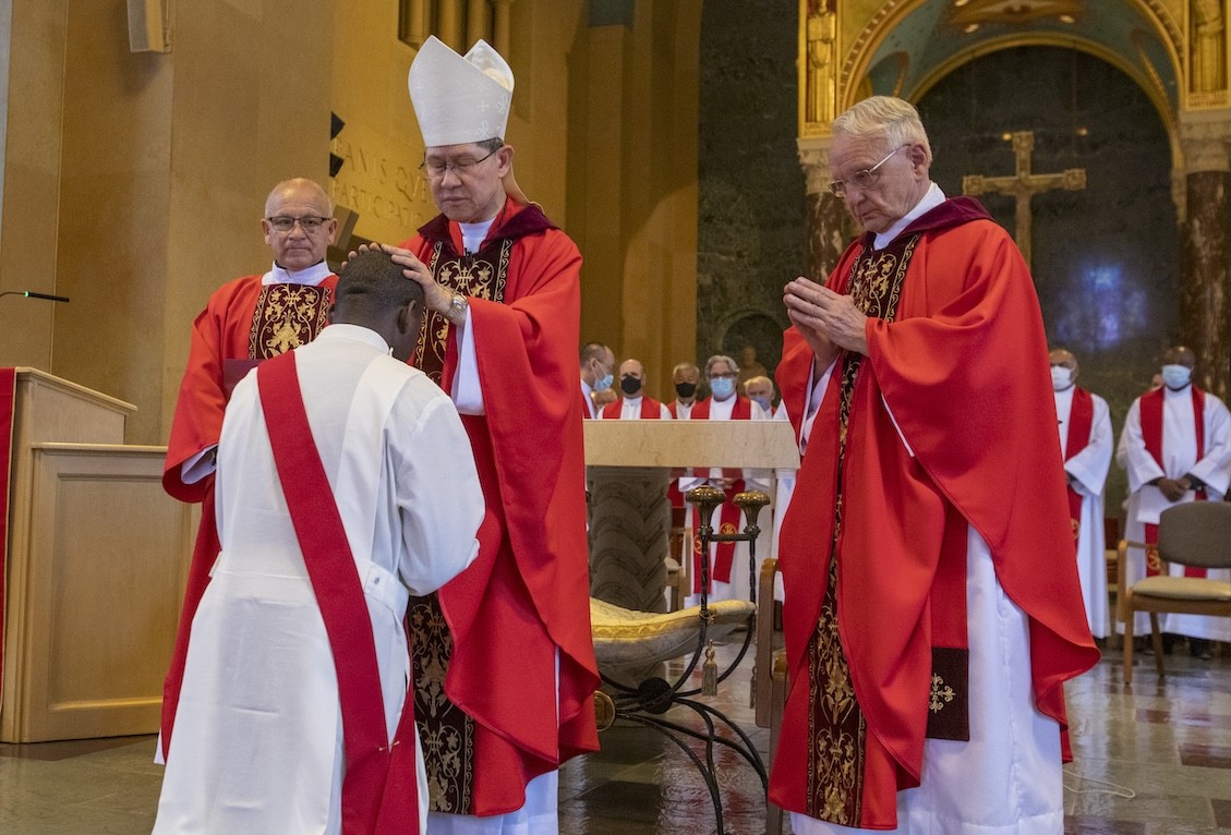 Maryknoll Superior General Father Lance P. Nadeau, who became Siyumbu’s mentor while serving as chaplain at Kenyatta University, blesses Siyumbu as Deacon Carlos Campoverde (left) and Cardinal Tagle look on.