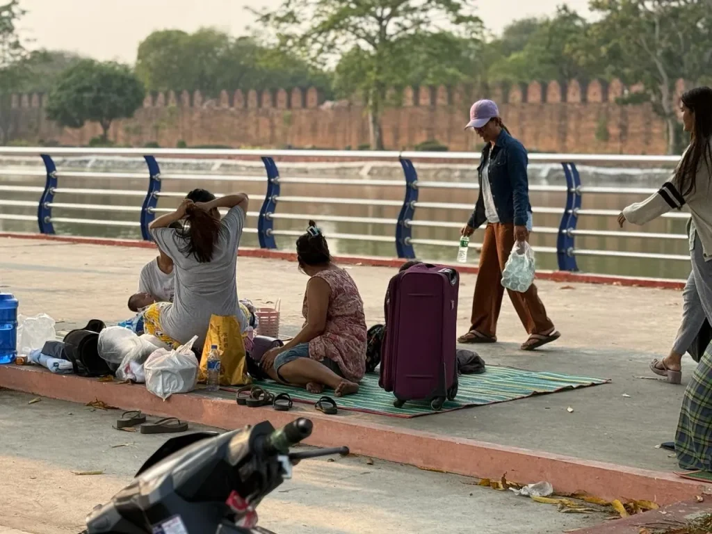 A family with a baby is seeking shelter in a parking area after the earthquake in Myanmar