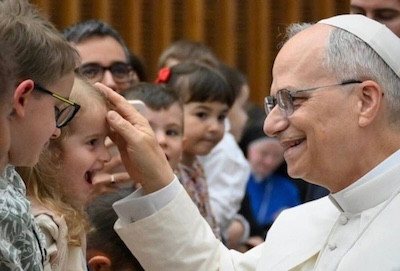Pope Leo blesses a smiling child