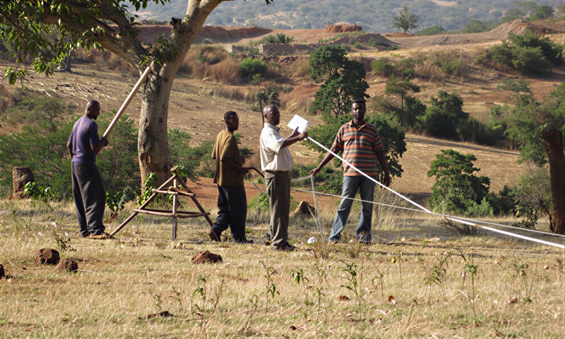 Men planning for reforestation using Moringa Oleifera trees and a solar powered well within St. John the Baptist Parish, Kibwezi, Kenya