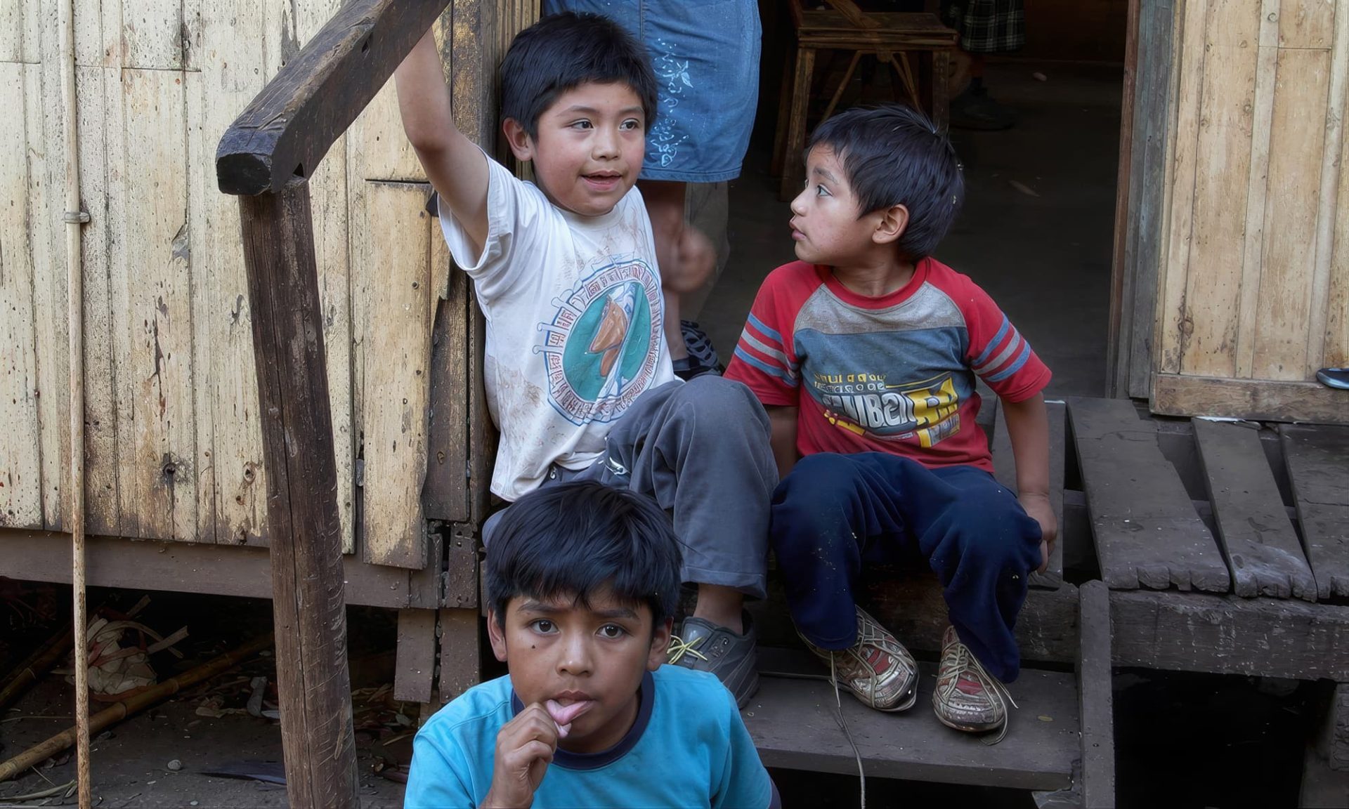 A mother and three children in temporary immigrant housing in Curico, Chile