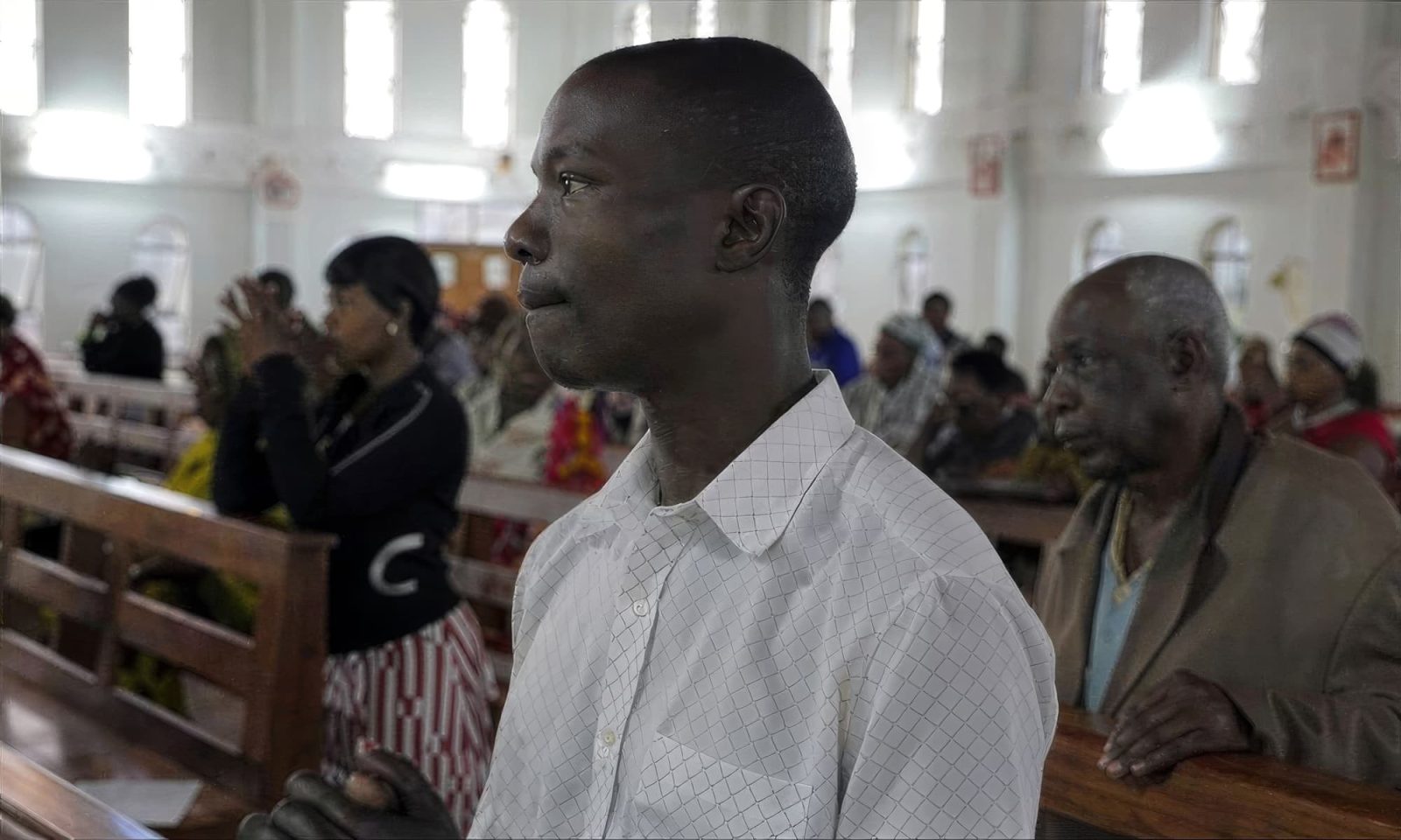 A young seminarian attending church at the Catholic Diocese of Shinyanga in Tanzania